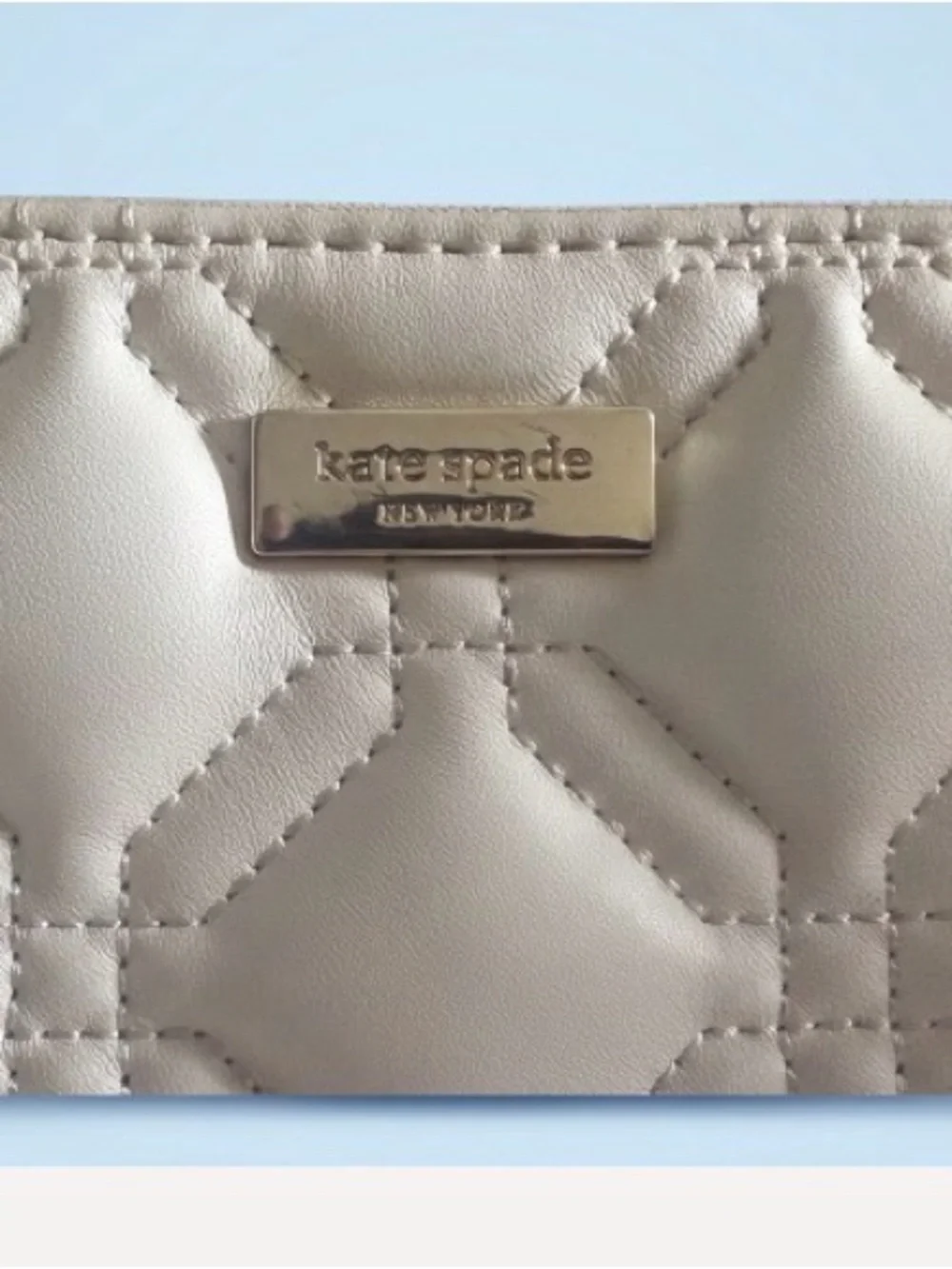 kate spade Cream Quilted Wristlet Clutch with Gold Logo